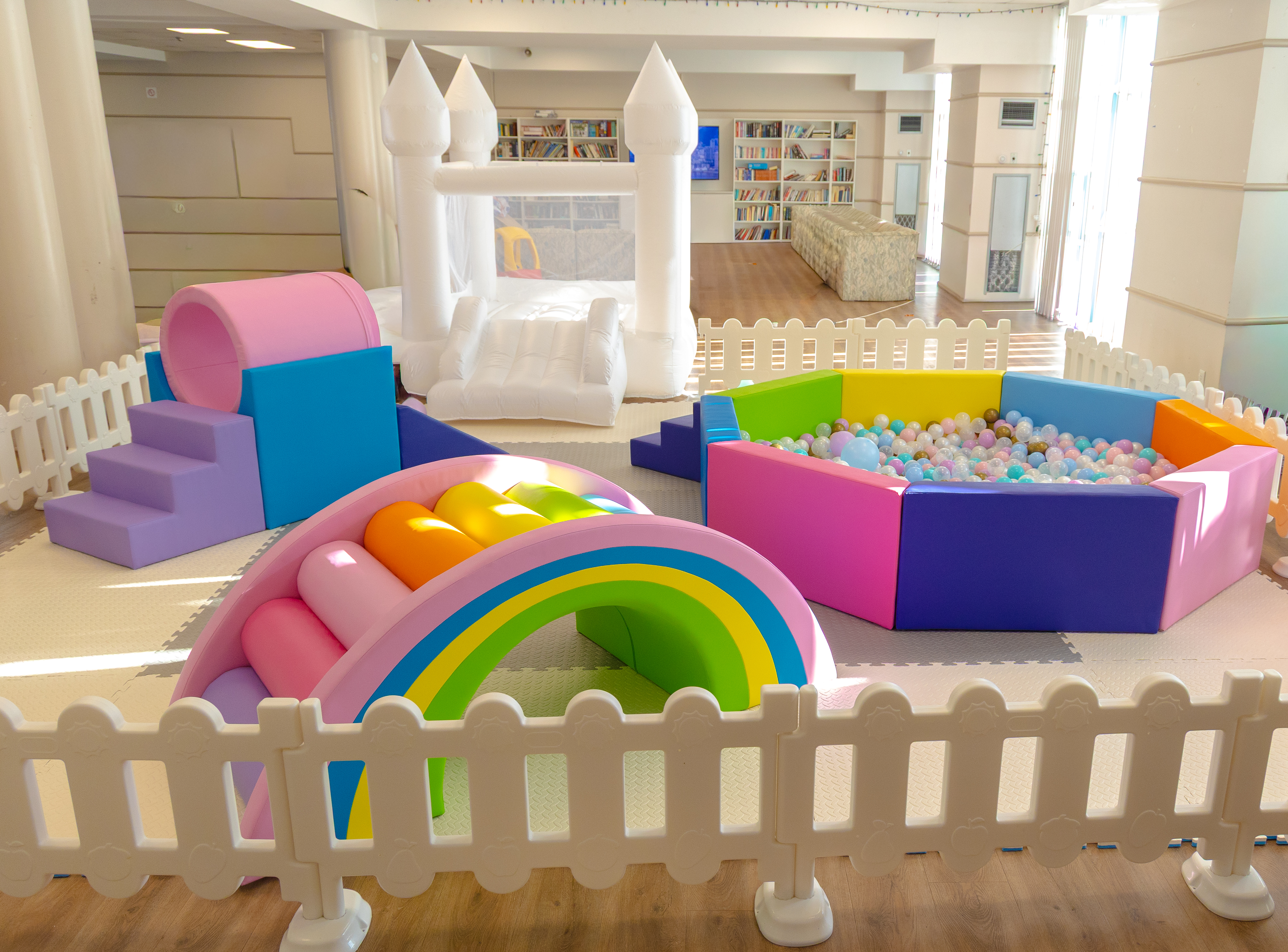 Luxury soft play rental with white bounce house, colourful ball pit and toddler play area